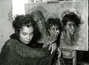 L'artista mentre dipinge "Autoritratto con Kot e Sergio" (1955)