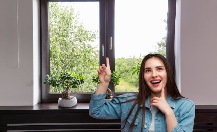 una ragazza che indica la finestra