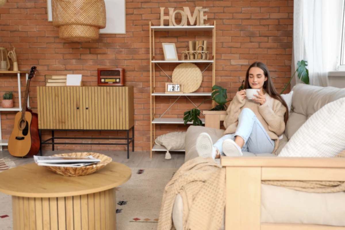 donna sul divano con in mano una tazza