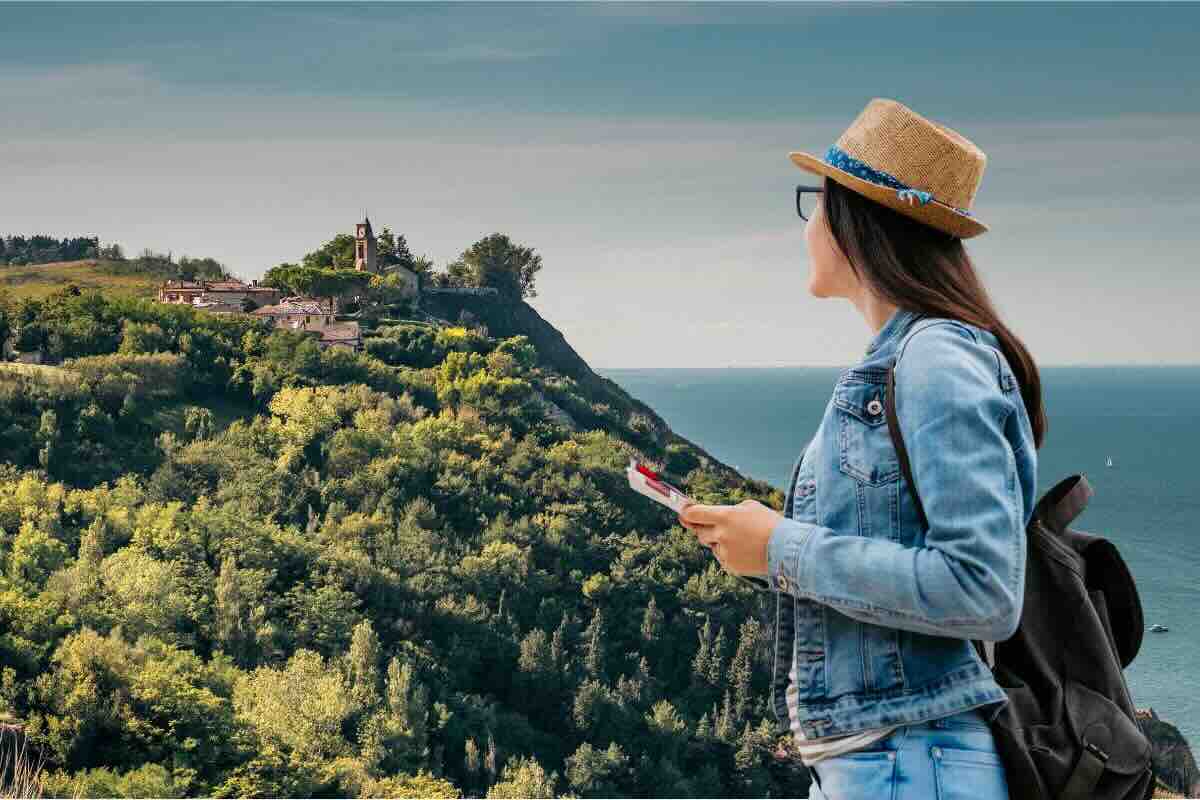 Borgo su promontorio, ragazza con cartina