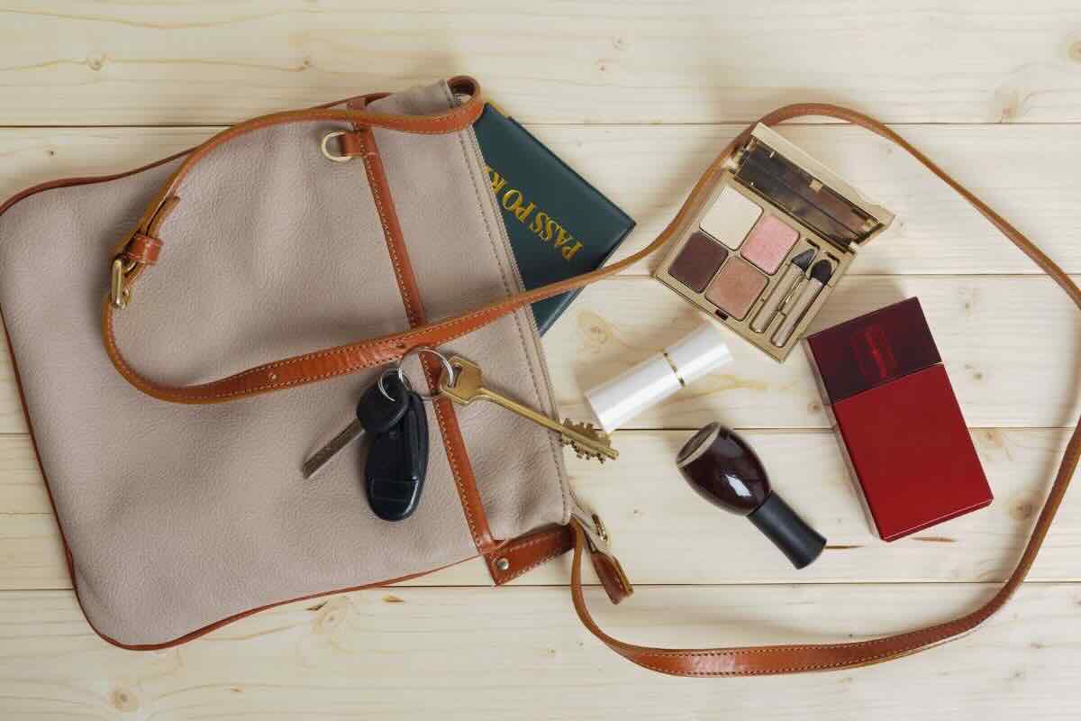 Borsa con chiavi, passaporto, palette trucco, torcia