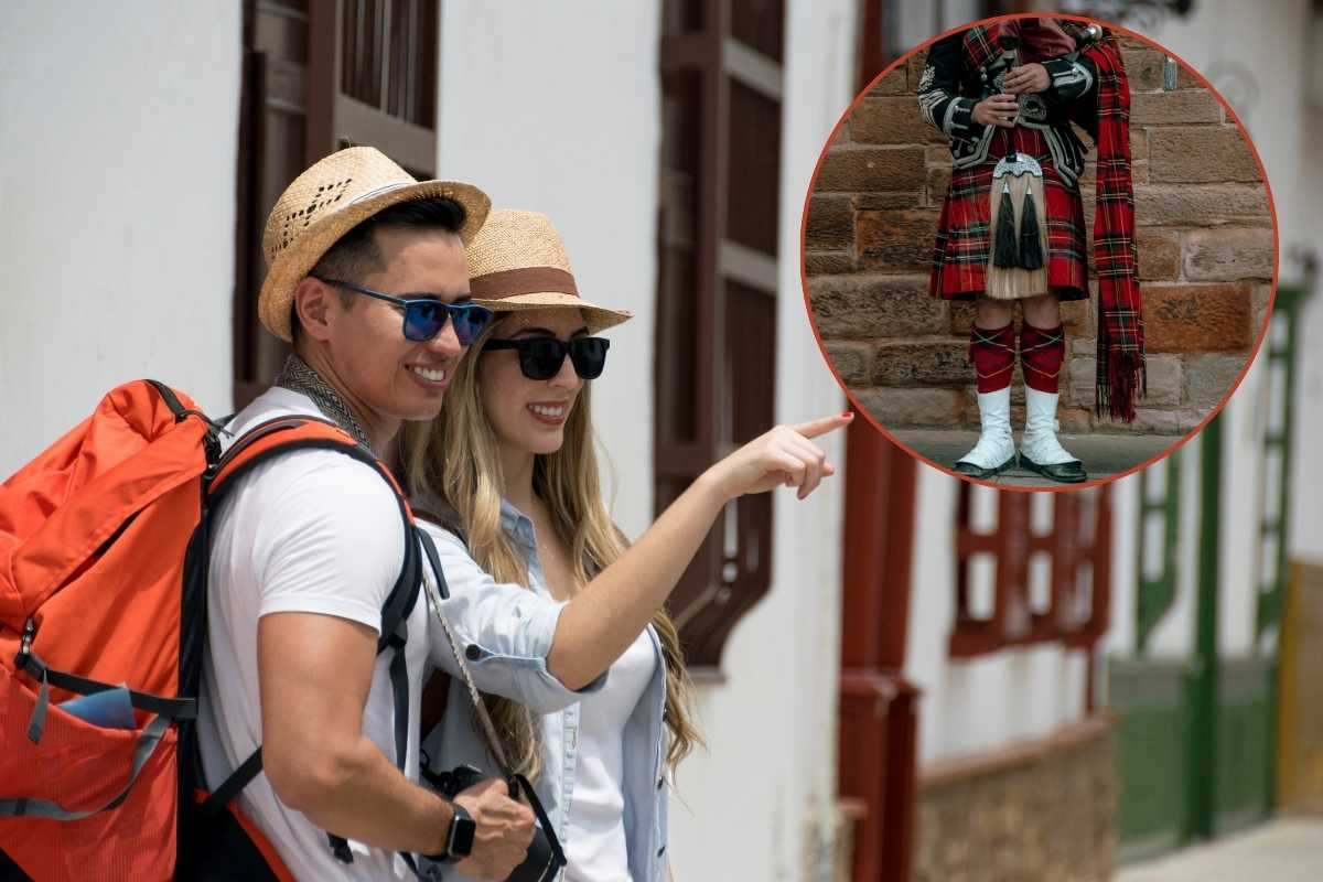 una coppia di turisti e persona vestita scozzese